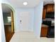 Welcoming foyer with tiled floor, wooden doors, and kitchen access with modern appliances at 2443 Torrens Dr, Lakeland, FL 33805
