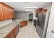 Well-equipped kitchen features granite counters, stainless steel appliances, and tile floors at 2443 Torrens Dr, Lakeland, FL 33805