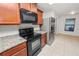 Modern kitchen with stainless steel appliances, granite countertops, tile floor and sleek black oven at 2443 Torrens Dr, Lakeland, FL 33805