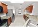 Bright kitchen featuring granite countertops, stainless steel appliances, and tiled flooring at 2443 Torrens Dr, Lakeland, FL 33805