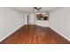 Open-concept living area with modern wood floors, ceiling fan, seamlessly connected to entry and kitchen at 2443 Torrens Dr, Lakeland, FL 33805