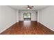 A spacious living area with a sliding door opens to the backyard, complemented by elegant wood flooring at 2443 Torrens Dr, Lakeland, FL 33805