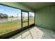 Covered patio looking out onto the fenced back yard and a tranquil lake view at 2443 Torrens Dr, Lakeland, FL 33805