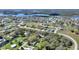 An aerial view shows home in a mature neighborhood with lakes and many trees at 246 Laynewade Rd, Polk City, FL 33868