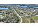 An aerial view shows home located in a mature neighborhood with lakes and many trees at 246 Laynewade Rd, Polk City, FL 33868