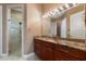 Elegant bathroom featuring granite counters, cherry wood cabinets, and a glass enclosed shower at 246 Laynewade Rd, Polk City, FL 33868