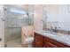 Well-lit bathroom showcasing tile shower, granite counters, and wood cabinets at 246 Laynewade Rd, Polk City, FL 33868