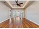 Spacious bedroom featuring wood floors, a tray ceiling, and a ceiling fan at 246 Laynewade Rd, Polk City, FL 33868