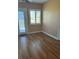 Bedroom with wood-look flooring, natural light, and a glass door leading to an outdoor space at 246 Laynewade Rd, Polk City, FL 33868