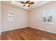 This bedroom features two windows, wood floors, and a ceiling fan at 246 Laynewade Rd, Polk City, FL 33868