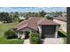 Charming single-story home with well-manicured lawn, mature palms, and a two-car garage at 246 Laynewade Rd, Polk City, FL 33868