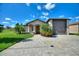 Charming single-story home with manicured landscaping and a spacious driveway at 246 Laynewade Rd, Polk City, FL 33868