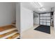 Spacious garage with stairs leading to the upper level and an automatic garage door at 246 Laynewade Rd, Polk City, FL 33868