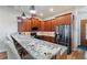 Modern kitchen with granite countertops, stainless steel appliances, and wood cabinets at 246 Laynewade Rd, Polk City, FL 33868