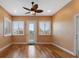 Bright living room featuring wood floors, a ceiling fan, and natural light from the windows at 246 Laynewade Rd, Polk City, FL 33868