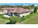 Back of a well-maintained home featuring a fenced yard and stone patio at 246 Laynewade Rd, Polk City, FL 33868