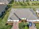 Aerial view of a single story home with a large roof and a beautiful brick driveway and landscaped yard at 2820 Attwater Loop, Winter Haven, FL 33884