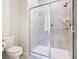Bathroom with tiled walk-in shower and toilet at 2820 Attwater Loop, Winter Haven, FL 33884