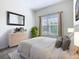 Bright bedroom with large window, neutral decor, and ample natural light at 2820 Attwater Loop, Winter Haven, FL 33884