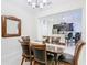 A formal dining room with wood table, leather chairs, and view of kitchen beyond at 2820 Attwater Loop, Winter Haven, FL 33884