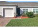 Charming single-story home with a well-manicured lawn, brick pathway, and attached single car garage at 2820 Attwater Loop, Winter Haven, FL 33884