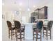 Beautiful kitchen with stainless steel appliances, island with seating, and modern lighting at 2820 Attwater Loop, Winter Haven, FL 33884