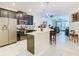 Open kitchen featuring stainless steel appliances, dark cabinetry, and a breakfast bar with seating at 2820 Attwater Loop, Winter Haven, FL 33884