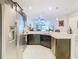 Modern kitchen with stainless steel appliances, dark cabinetry, and an open layout to the living area at 2820 Attwater Loop, Winter Haven, FL 33884