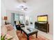Cozy living room with comfortable seating, a ceiling fan, and a sliding glass door for natural light at 2820 Attwater Loop, Winter Haven, FL 33884