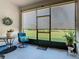 Relaxing enclosed patio with chairs and a view of the well-maintained lawn and landscaping at 2820 Attwater Loop, Winter Haven, FL 33884