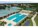 An aerial shot of a pool and recreation area with tennis courts and lots of chairs for sunbathing at 2820 Attwater Loop, Winter Haven, FL 33884