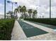 Community shuffleboard courts nestled amongst palm trees and hedges at 2820 Attwater Loop, Winter Haven, FL 33884