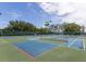 Bright and spacious tennis courts with lush landscaping create an inviting recreational space for residents and guests at 2820 Attwater Loop, Winter Haven, FL 33884