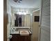 Tiled bathroom with a walk-in shower and neutral-toned sink at 3030 Sun Way, Lakeland, FL 33801