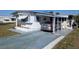 Exterior of home with driveway, carport, and tidy landscaping at 3030 Sun Way, Lakeland, FL 33801
