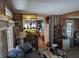 Cozy living room featuring wood paneling and view into kitchen with decorations at 3030 Sun Way, Lakeland, FL 33801