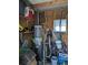 Utility room with a water heater, shelving, and various tools at 3030 Sun Way, Lakeland, FL 33801