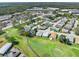 An aerial view showcases homes nestled near a golf course with lush green fairways, and easy access to shops at 3158 Pebble Bend Dr, Lakeland, FL 33810