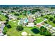 Aerial view of community with mature trees, golf course, swimming pool, ponds, and tennis courts at 3158 Pebble Bend Dr, Lakeland, FL 33810