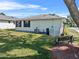 Well-maintained backyard with lawn, bench, and the home's exterior, perfect for relaxing or entertaining at 3158 Pebble Bend Dr, Lakeland, FL 33810