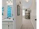 Hallway view featuring a bathroom with blue accents and unique armoire at 3158 Pebble Bend Dr, Lakeland, FL 33810