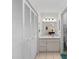 Bathroom featuring tile flooring, white cabinets and an adjacent closet with plenty of storage space at 3158 Pebble Bend Dr, Lakeland, FL 33810