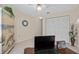 Well-lit bedroom with a desk, unique armoire, ceiling fan and natural light at 3158 Pebble Bend Dr, Lakeland, FL 33810
