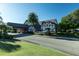 Inviting tudor style building, mature trees, lush landscaping, and convenient covered drop off area at 3158 Pebble Bend Dr, Lakeland, FL 33810