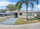 Charming single-story home with a well-maintained lawn, mature palm tree, and cozy covered carport at 3158 Pebble Bend Dr, Lakeland, FL 33810