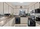 Well-lit kitchen featuring sleek black appliances, countertop with sink and ample cabinet space at 3158 Pebble Bend Dr, Lakeland, FL 33810