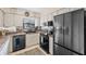 Modern kitchen featuring black appliances, white cabinetry and stainless steel refrigerator at 3158 Pebble Bend Dr, Lakeland, FL 33810