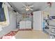 Neat laundry room with appliances, shelving, ceiling fan, and convenient access to an outdoor area at 3158 Pebble Bend Dr, Lakeland, FL 33810