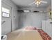 Functional laundry room with appliances, open shelving, a ceiling fan, and natural light from a small window at 3158 Pebble Bend Dr, Lakeland, FL 33810