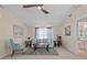 Cozy living room with neutral carpet, ceiling fan, and access to the kitchen at 3158 Pebble Bend Dr, Lakeland, FL 33810